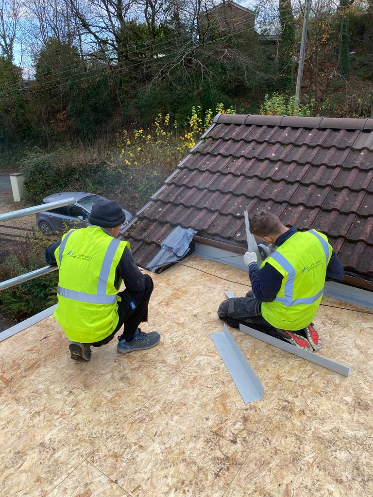 Two roofers installing a residential roof