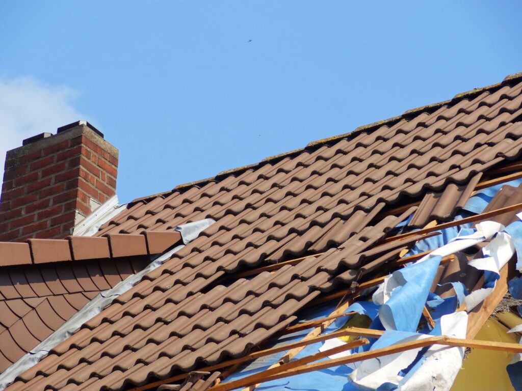 Domestic roof damaged a caused by storm